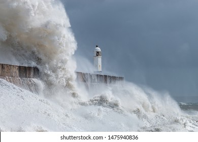 Huge Ocean Waves Crashing Into A Sea Wall And Lighthouse (Porthcawl, South Wales, UK)