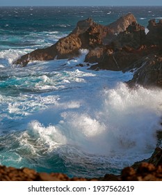 Huge Ocean Waves Crashing On The Rocks In Sunset