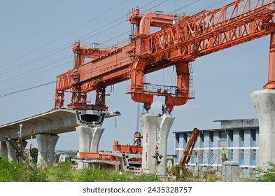 Huge orange dislocation bridge construction overhead crane for construction of elevated railway in Thailand