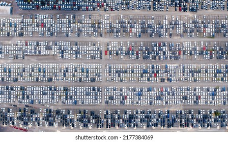 Huge Parking Lot Near Big City. Overhead View Of Big Car Parking.
Aerial View Of New Cars Parked At The Parking Area Of Automobile Factory. Aerial View Above Multicolored Cars On Warehouse Parking Lot