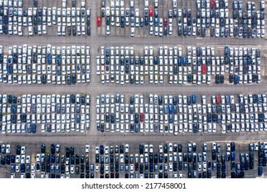 Huge Parking Lot Near Big City. Overhead View Of Big Car Parking.
Aerial View Of New Cars Parked At The Parking Area Of Automobile Factory. Aerial View Above Multicolored Cars On Warehouse Parking Lot