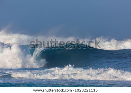 huge perfect wave breaking at pipeline beach in hawaii