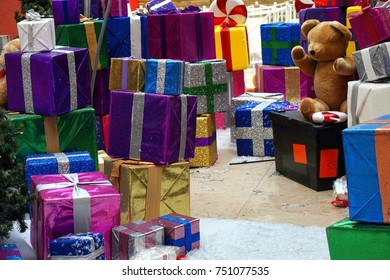 Huge Pile Of Christmas Presents And Teddy Bear In A Shopping Mall Ready For The Holiday Season