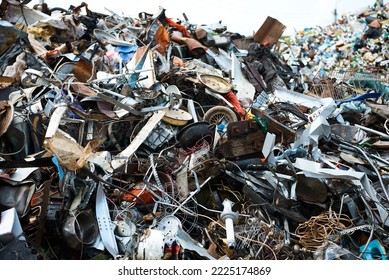 Huge pile of different waste items in recycling plant yard - Shutterstock ID 2225174869