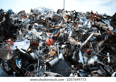 Huge pile of different waste items in recycling plant yard