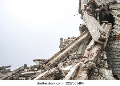 A Huge Pile Of Gray Concrete Debris From Piles And Stones Of The Destroyed Building. The Impact Of The Destruction. The Impact Of The Destruction. Background.