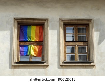A huge rainbow flag LGBT social movement hanging in a window in a tenement house in Jewish district Kazimierz in Cracow. Selected focus.