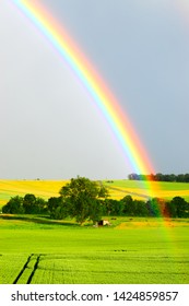 huge rainbow over green fields - Shutterstock ID 1424859857