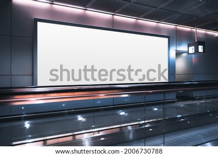 A huge rectangular empty billboard mockup next to travelator in a modern airport departure area; a white blank poster template indoors of a terminal of public transport building near a moving walkway
