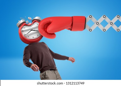 Huge Red Boxing Glove Punching Man With An Alarm Clock Instead Of His Face On Blue Background. Final Deadline. Time Expired. Time Planning.