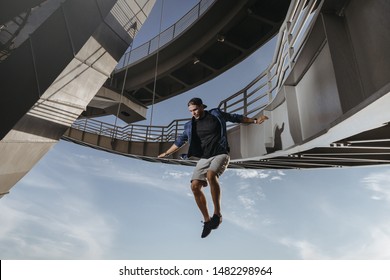 Huge and risky jump from a bridge performed by parkour athlete. Freedom in Freerunning - Powered by Shutterstock