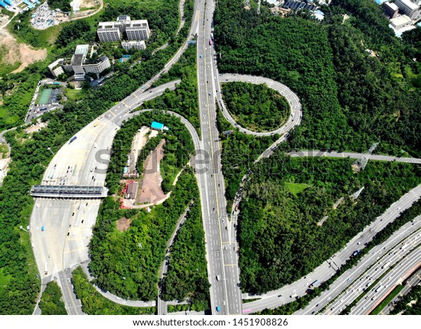 Huge road junction. The highest level of road\
construction, admiring the eye. Photo made by drone. Bird flight.\
Shenzhen, China.