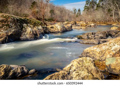 Huge Rocks And The Flowing Waters Of Eno River Captured During Winter Season. This Is One Of The Best Parks In Durham, North Carolina For Nature Hikes And Camping, Just Few Miles From Duke University.