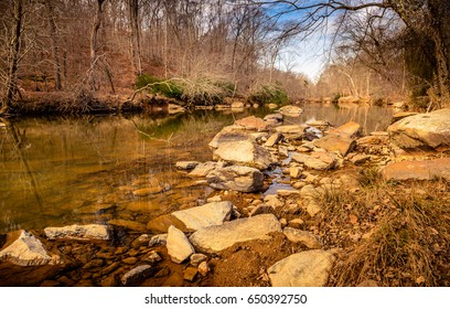 Huge Rocks And The Flowing Waters Of Eno River Captured During Winter Season. This Is One Of The Best Parks In Durham, North Carolina For Nature Hikes And Camping, Just Few Miles From Duke University.