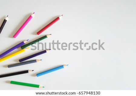 Huge set of colorful pencils on white table background. Top view. 
