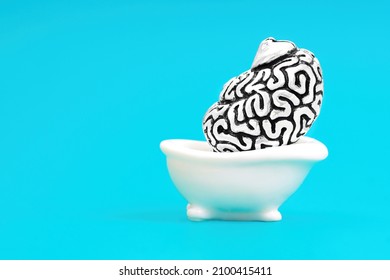 Huge Steel Copy Of A Human Brain Taking A Hot Tub Isolated On A Blue Background. Spa Treatment Of A Drained Mind Concept.