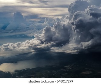 huge storm cloud, tower cumulus and cumulonimbus cloud, develop over sea and lake at dawn - Powered by Shutterstock