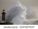 Huge stormy wave at the old lighthouse and granite pier from the Douro river mouth, north of Portugal.