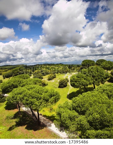 Huge suburban park of Madrid and flying spring the clouds photographed from a moving cable car