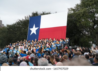 huge Texas flag with huge crowds of democratic socialist political movement supporters at Bernie Sanders Rally in Austin Texas USA on February 23rd 2020
