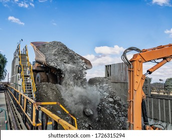 Huge Truck Unloading Kimberlite In A Crusher In An Open Pit Diamond Mine , In Botswana