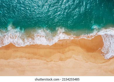 Huge turquoise waves breaking on a lonely sandy beach on Sri Lanka island near Tangalle town Hambantota District. Traveling or exotic Asian countries aerial drone point view concept.