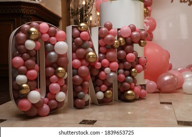 huge volumetric inscription one for celebration in a restaurant with small balloons