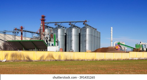 Huge warehouse facilities for agricultural sector  under clear blue sky near field