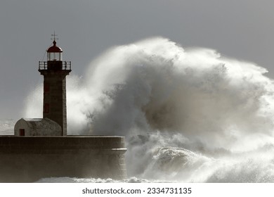 Huge wave over old lighthouse of Porto, Portugal. Low edition photo.