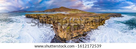 Huge waves breaking at Muckross Head - A small peninsula west of Killybegs, County Donegal, Ireland. The cliff rocks are famous for climbing.