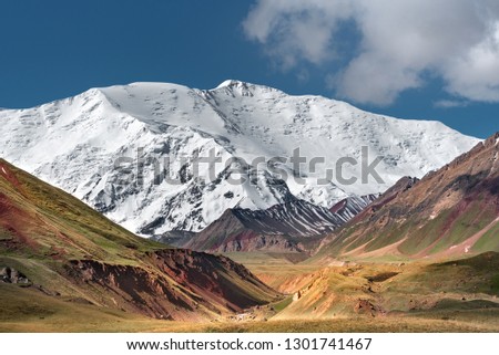 Huge white snow mountain. Mountain landscape. Lenin peak.