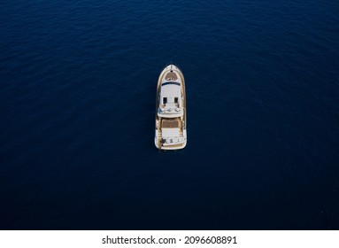 Huge White Super Mega Yacht On Blue Water In Italy. White Sport Yacht Open Sea Aerial View. Super Yacht On Blue Water Top View.