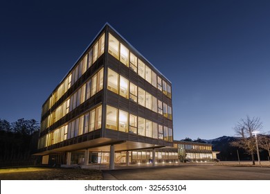 huge wooden timber sustainable office building at dawn