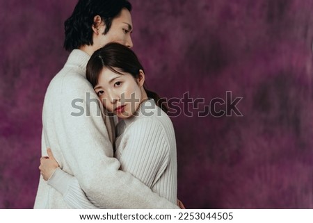 Hugging Asian couple. Romantic drama concept.