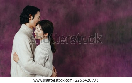 Hugging Asian couple. Romantic drama concept.