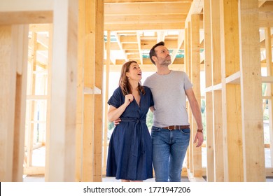 Hugging Couple At Construction Site Of Their New Home, Dreams Come True