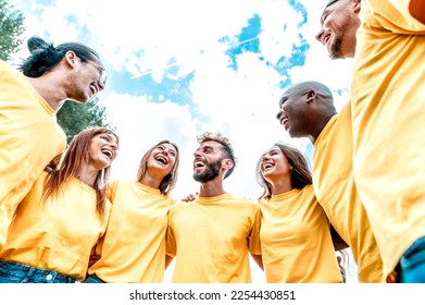 Hugging each other and smiling a group of volunteer people helping others - A coluoured team of Men and Women from different ethnicities embrace in a circle - Joyful community lifestyle concept.	
 - Shutterstock ID 2254430851