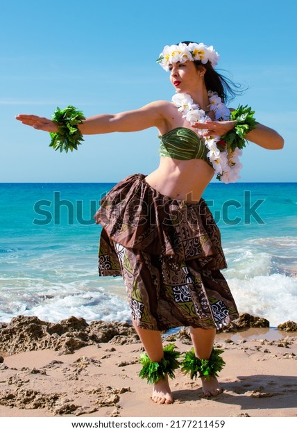 Hula dancer on the beach. Woman in bikini dancing\
Hawaiian typical of Tahiti. Tropical lady at beach with flower\
crown on her head and neck. Ready to party. Exotic girl in\
swimwear. Trend promo\
summer