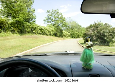 Hula Girl On Dashboard Of Car Interior.