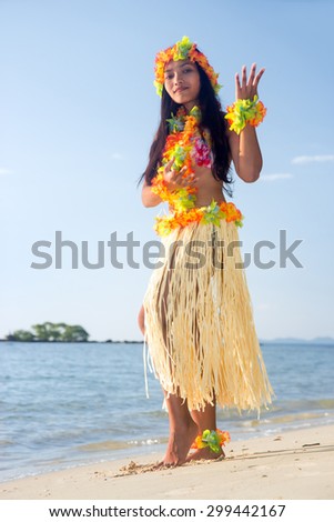 Hula Hawaii dancer dancing on the sea beach. Exotic vacation on a tropical island..