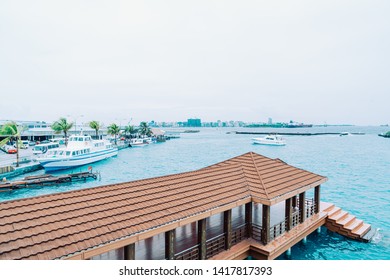 HULHULE, MALDIVES - MAY 23, 2019: Boats and ferries at the harbor outside Velana airport in Hulhule.