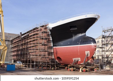 
Hull of big ship under construction at shipyard.
