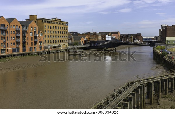 Hull,\
Humberside, UK. River Hull at low tide with view of Scale Lane\
swing bridge (closed), beached obsolete ship, and flanked by\
buildings near the estuary, Hull, Humberside,\
UK.