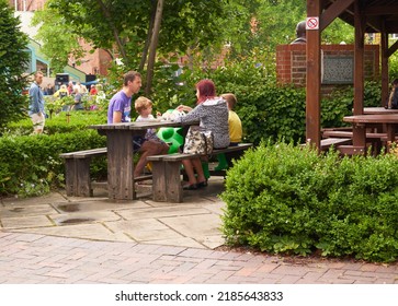 Hull, UK 07 29 2022 Family At A Picnic Bench           