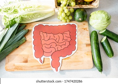 Human Belly Drawing On The Cutting Board With Fresh Green Food, View From Above. Food For Belly Health Concept