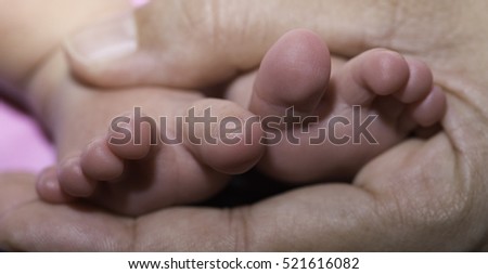 Human body parts, close up of mixed race baby Asian and British new born baby showing details and natural development of the human body.
