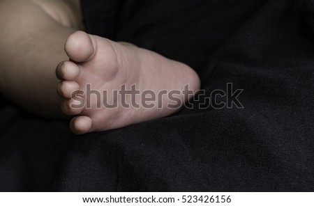 Human body parts toes and feet. Close up of mixed race baby Asian and British new born baby showing details and natural development of the human body.