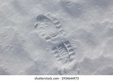 Human Boots Footprints In Snow. Boot Print On The Snow.