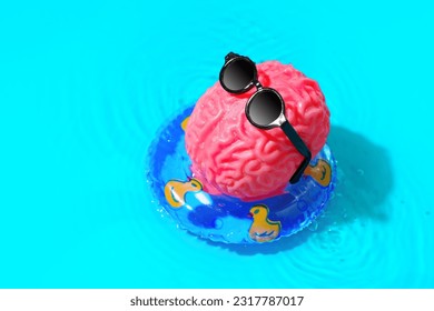 Human brain character, adorned with stylish sunglasses, indulges in a relaxing sunbathing session as it floats gracefully in a pool ring. Mental rejuvenation, leisure and self-care concept.