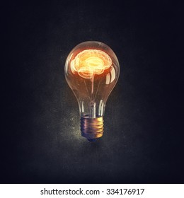 Human brain glowing inside of light bulb on dark background - Shutterstock ID 334176917